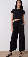 Load image into Gallery viewer, Smocked Ruffle Waist Wide Leg Crop in Black

